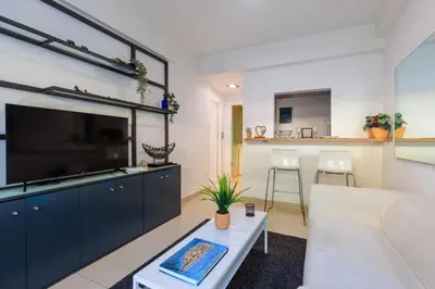 a living room with a large flat screen tv at AIOLOS glyfada centre apartment 2 in Athens