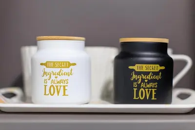 two jars on a plate next to two cups at AIOLOS glyfada centre apartment 2 in Athens