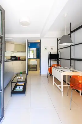 a kitchen and living room with a table and chairs at AIOLOS glyfada centre apartment 3 in Athens