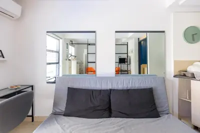 a bedroom with a bed with a mirror above it at AIOLOS glyfada centre apartment 3 in Athens