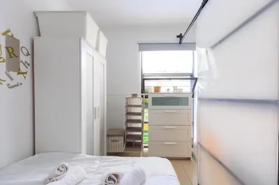 a bedroom with a bed with towels on it at AIOLOS glyfada centre apartment 3 in Athens