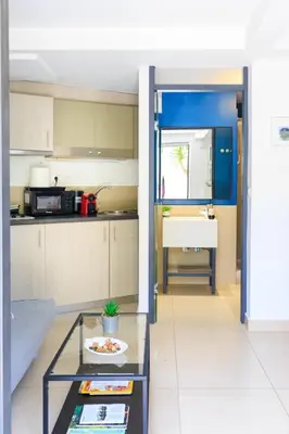 a living room with a table and a kitchen at AIOLOS glyfada centre apartment 3 in Athens