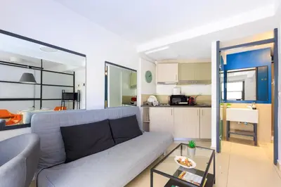a living room with a couch and a kitchen at AIOLOS glyfada centre apartment 3 in Athens
