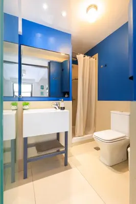 a bathroom with a white sink and a toilet at AIOLOS glyfada centre apartment 3 in Athens