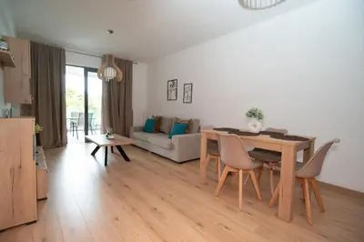 a kitchen and living room with a table and chairs at Elegant apartment in Agia Paraskevi-B2 in Athens
