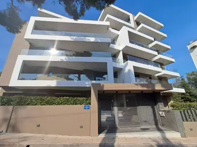 a large white building with a green roof at Elegant apartment in Agia Paraskevi-B2 in Athens