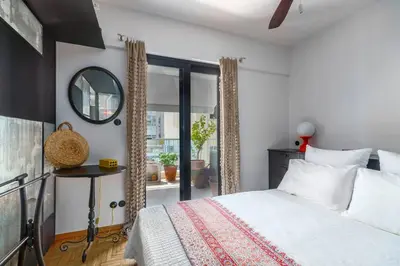 a bedroom with a bed and a mirror and a window at Stylish 2bed home in Syntagma area in Athens