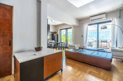 a kitchen with a couch in the middle of a room at Stylish 2bed home in Syntagma area in Athens
