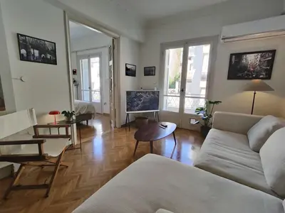 a living room with a couch and a table at Stylish 1BR Apt with Retro Kitchen View Balcony in Athens