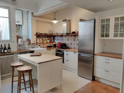 a kitchen with white cabinets and a stainless steel refrigerator at Stylish 1BR Apt with Retro Kitchen View Balcony in Athens