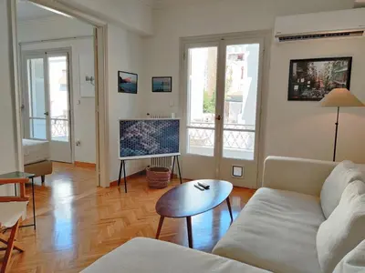 a living room with a couch and a tv at Stylish 1BR Apt with Retro Kitchen View Balcony in Athens