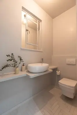 a white bathroom with a sink and a toilet at Acropolis Museum Retreat - 2 Bedroom Apartment in Athens