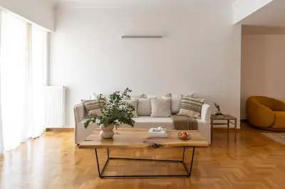 a living room with a couch and a coffee table at Acropolis Museum Retreat - 2 Bedroom Apartment in Athens
