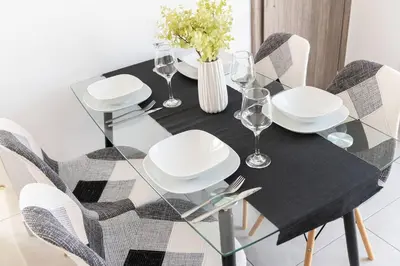 a dining room table with a black and white table and chairs at City-View Apartment by Piraeus Port - DRF2 in Piraeus