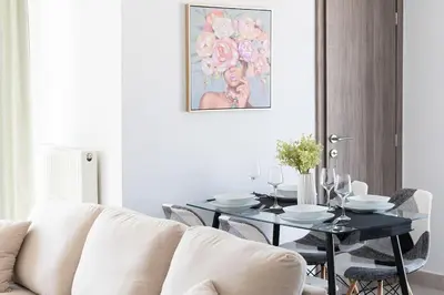 a living room with a table and a white couch at City-View Apartment by Piraeus Port - DRF2 in Piraeus