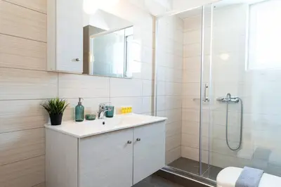 a bathroom with a sink and a shower at City-View Apartment by Piraeus Port - DRF2 in Piraeus