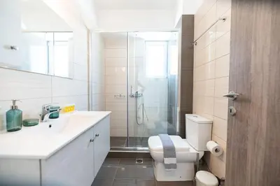 a bathroom with a shower and a toilet and a sink at City-View Apartment by Piraeus Port - DRF2 in Piraeus