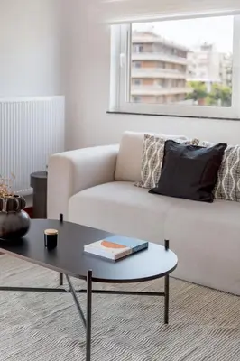 a living room with a couch and a coffee table at Athenian 3BR seaside property in Alimos by UPSTREET in Athens