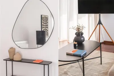 a living room with a table and a mirror at Athenian 3BR seaside property in Alimos by UPSTREET in Athens