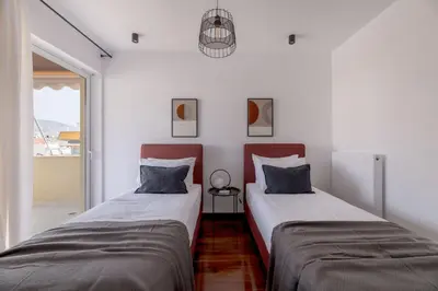 two beds sitting next to each other in a room at Athenian 3BR seaside property in Alimos by UPSTREET in Athens