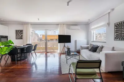 a living room with a couch and a table at Athenian 3BR seaside property in Alimos by UPSTREET in Athens