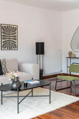 a living room with a couch and a coffee table at Athenian 3BR seaside property in Alimos by UPSTREET in Athens