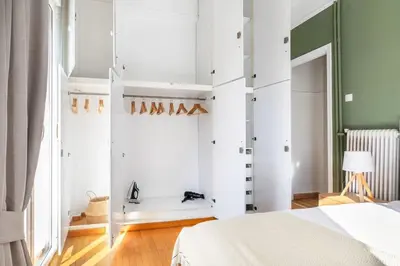 a bedroom with white walls and a bed at Modern Apt opposite the Acropolis Museum in Athens
