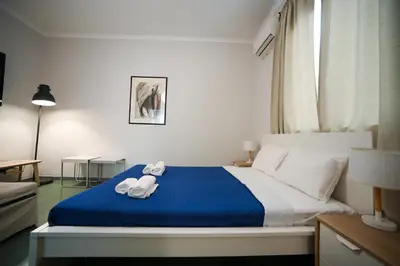a bedroom with a bed with towels on it at Athenian Suite by Zeussuites in Athens