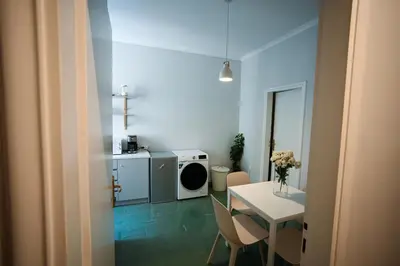 a small room with a table and a washing machine at Athenian Suite by Zeussuites in Athens