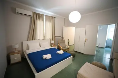 a bedroom with a bed with two towels on it at Athenian Suite by Zeussuites in Athens