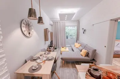 a living room with a table and a couch at Design drop in Athens ' center in Athens