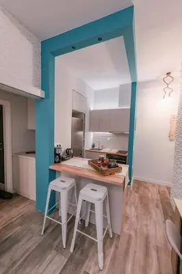 a kitchen with a counter and two stools in it at Design drop in Athens ' center in Athens