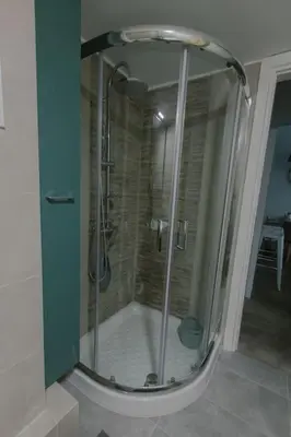 a shower with a glass door in a bathroom at Design drop in Athens ' center in Athens