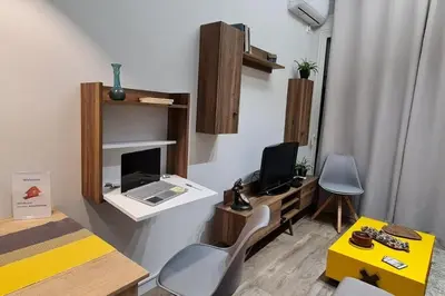 a room with a desk with a laptop computer on a table at Design drop in Athens ' center in Athens