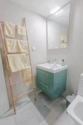 a bathroom with a sink and a ladder with a mirror at Design drop in Athens ' center in Athens