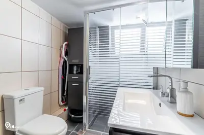 a bathroom with a toilet and a sink at Hephaestus - Luxury & Modern Apartment in Psychiko in Athens