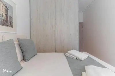 a white bed with two pillows in a room at Hephaestus - Luxury & Modern Apartment in Psychiko in Athens