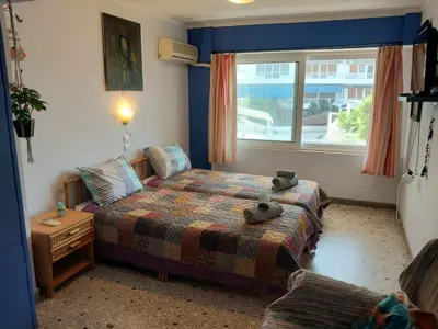 a bedroom with a bed with a teddy bear on it at Studio By The Beach 2 in Saronida