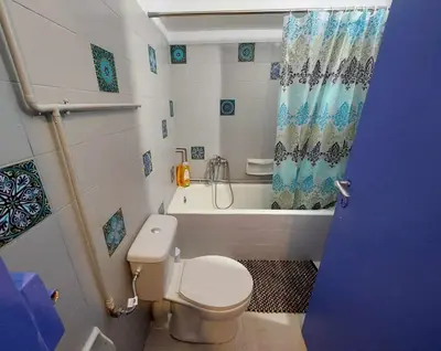 a bathroom with a toilet and a bath tub at Studio By The Beach 2 in Saronida