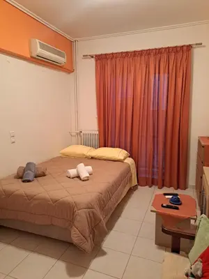 a bedroom with a bed with two towels on it at Minimal Stoudio in Athens