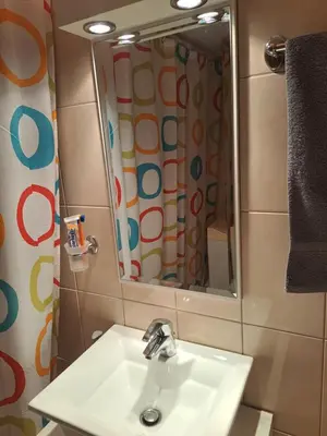 a bathroom with a sink and a mirror at Minimal Stoudio in Athens