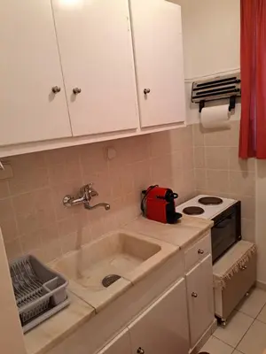 a kitchen with a sink and a stove at Minimal Stoudio in Athens