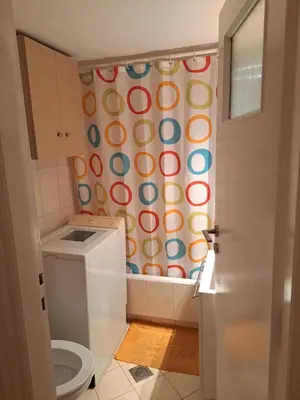 a bathroom with a toilet and a shower curtain at Minimal Stoudio in Athens