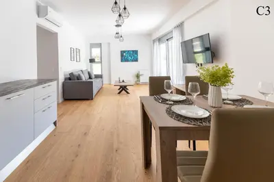 a kitchen and living room with a dining room table at Waylink Residences - Marina Floisvou in Athens