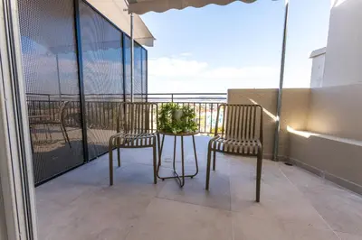 a balcony with two chairs and a table at Raise Area 41 in Athens
