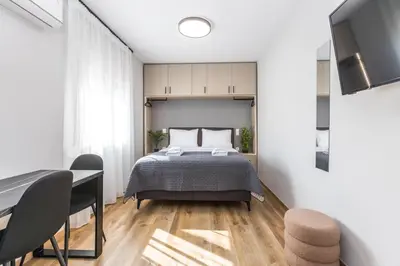 a bedroom with a bed and a table and chairs at Raise Area 41 in Athens