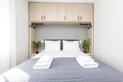 a bedroom with a large bed with white cabinets at Raise Area 41 in Athens