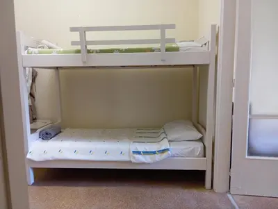 a bedroom with two bunk beds in a room at Bunk bed in dorm 5' from metro in Athens