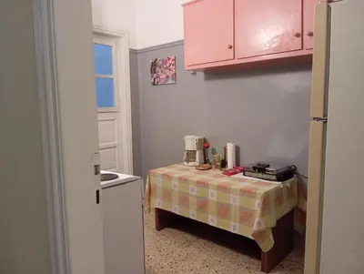 a kitchen with a table with a blender on it at Bunk bed in dorm 5' from metro in Athens