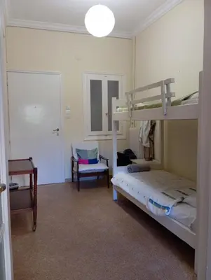 a bedroom with two bunk beds and a desk at Bunk bed in dorm 5' from metro in Athens